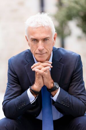 Portrait of confident businessman in suit outdoorsの写真素材