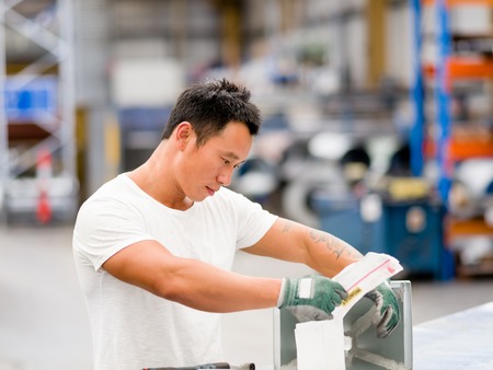 portrait of asian worker in production plant working on the factory floorの写真素材