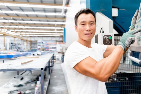 portrait of asian worker in production plant working on the factory floorの写真素材
