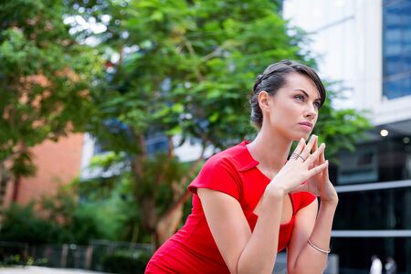 Portrait of beautiful business woman in red dressの写真素材