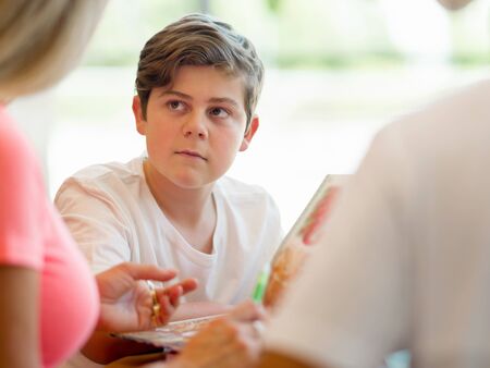 Family in library with booksの写真素材