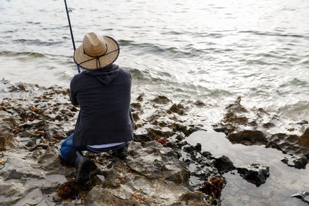 Picture of fisherman fishing with rodsの写真素材