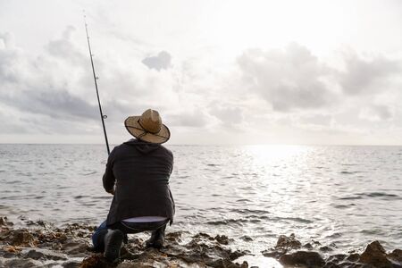 Picture of fisherman fishing with rodsの写真素材