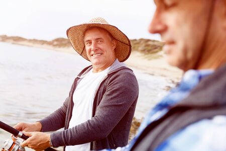 Picture of fishermen fishing with rodsの写真素材