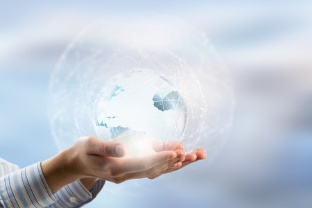 Global connection concept with digital planet in handsの写真素材