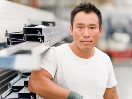 portrait of asian worker in production plant working on the factory floorの写真素材