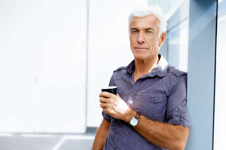 Handsome businessman in casual wear working in officeの写真素材