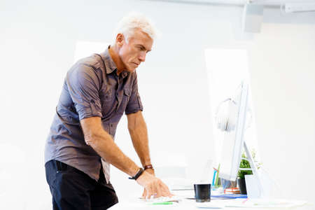 Handsome businessman in casual wear working in officeの写真素材