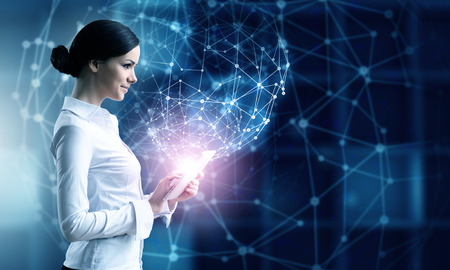 Businesswoman with tablet pc against high tech blue background Businesswoman with tablet pc against high tech blue background