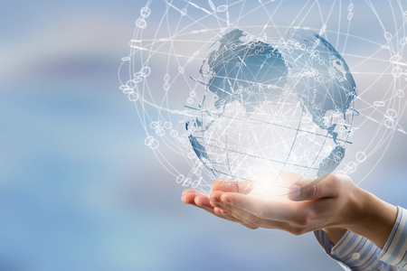 Global connection concept with digital planet in handsの写真素材