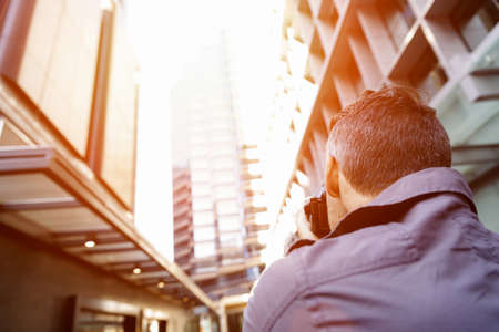 Professional photographer taking picture in city
