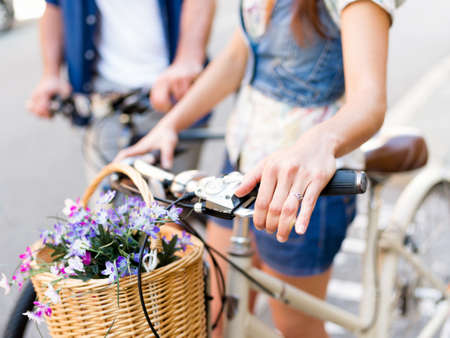 Happy young couple in city with bikeの写真素材