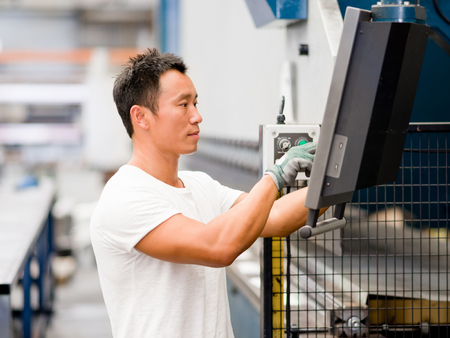 portrait of asian worker in production plant working on the factory floorの写真素材