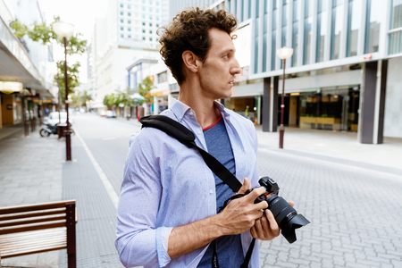 Professional photographer taking picture in cityの写真素材