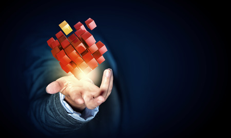 Businesswoman hand shows cube as symbol of problem solvingの写真素材