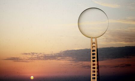 Imaginary image of ladder leading to circle door in skyの写真素材