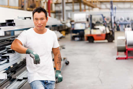 portrait of asian worker in production plant working on the factory floor