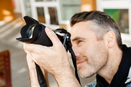 Professional photographer taking picture in cityの写真素材