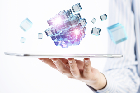 Businessman holding tablet and cube as symbol of problem solvingの写真素材