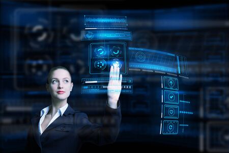 Attractive smiling businesswoman working with virtual panel interface