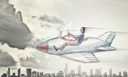 Young funny woman flying in air in drawn airplane