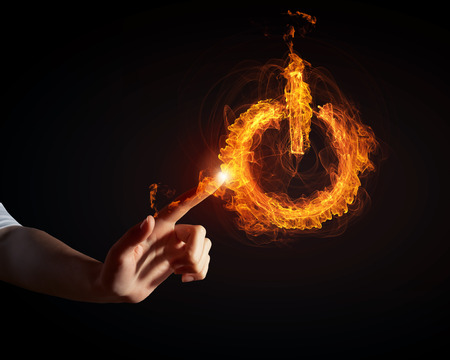 Glowing fire power icon of interface on dark backgroundの写真素材