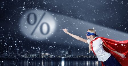 Young woman super hero and interest sign in spotlightの写真素材