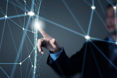 Businessman hand touching with finger digital connection lines on virtual screenの写真素材