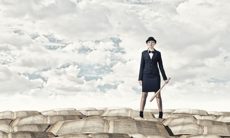 Young pretty woman in suit and hat with baseball batの写真素材