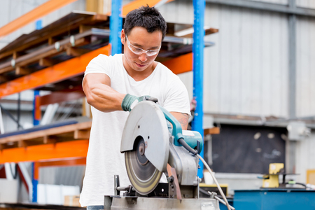 portrait of asian worker in production plant working on the factory floorの写真素材