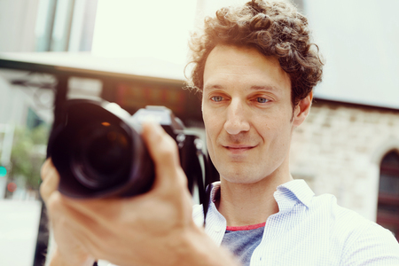 Professional photographer taking picture in cityの写真素材
