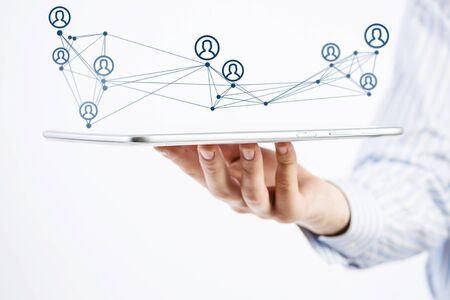 Close view of businessman holding tablet presenting social network conceptの写真素材