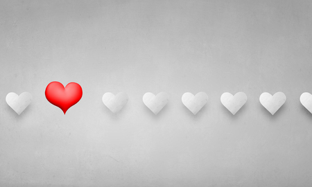 Person hand pointing with green arrow at red heartの写真素材