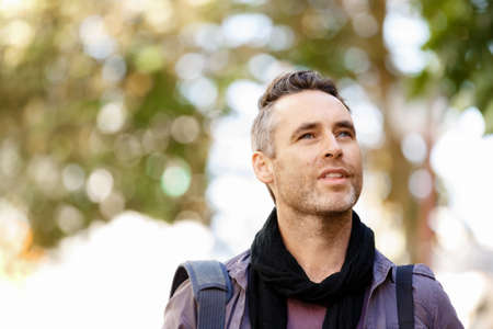 Happy male tourist in casual clothes in city walkingの写真素材