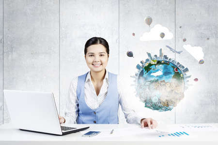Young smiling businesswoman working in office. Elements of this image are furnished by NASA