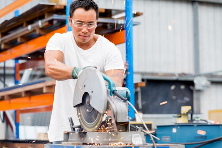 portrait of asian worker in production plant working on the factory floorの写真素材
