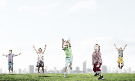 Group of children jumping high in sky joyfullyの写真素材