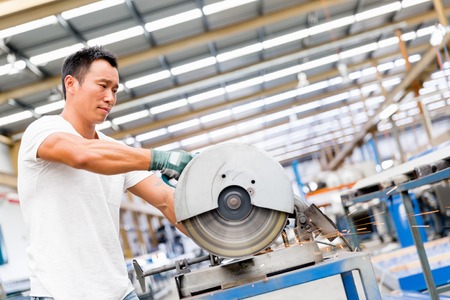 portrait of asian worker in production plant working on the factory floor