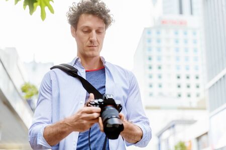 Professional photographer taking picture in city