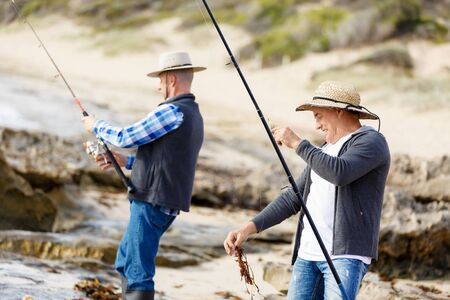Picture of fishermen fishing with rodsの写真素材
