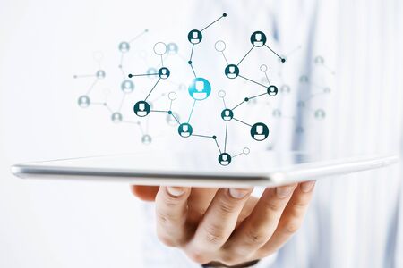 Close view of businessman holding tablet presenting social network concept
