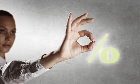 Percentage symbol and woman showing ok gestureの写真素材