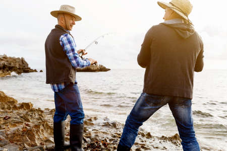 Picture of fishermen fishing with rodsの写真素材