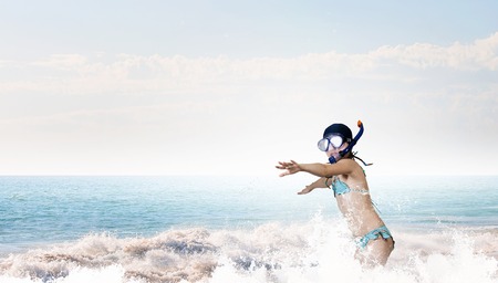 Kid girl of school age in diving mask having funの写真素材