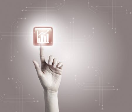 Male hand touching with finger growing graph iconの写真素材