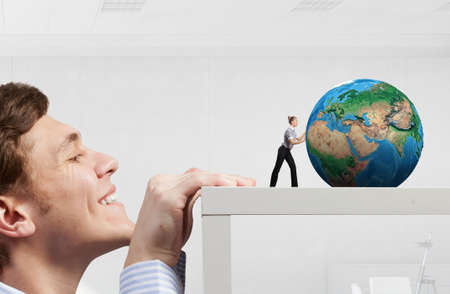 Young businesswoman pushing Earth planet. Elements of this image are furnished by NASAの写真素材