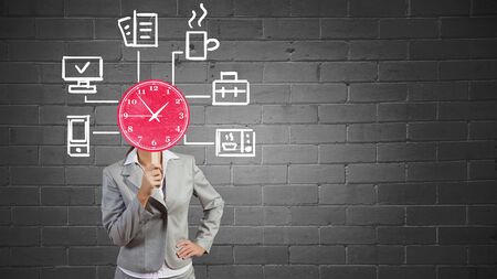 Businesswoman with card instead of face presenting time conceptの写真素材