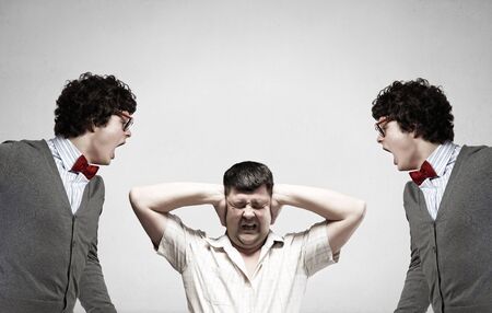 Fat depressed man covering ears with hands