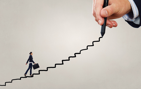 Businesswoman climbing up on drawn staircase as promotion conceptの写真素材
