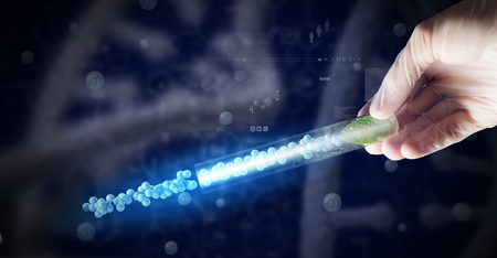 Close up of human hand holding test tube with green sproutの写真素材